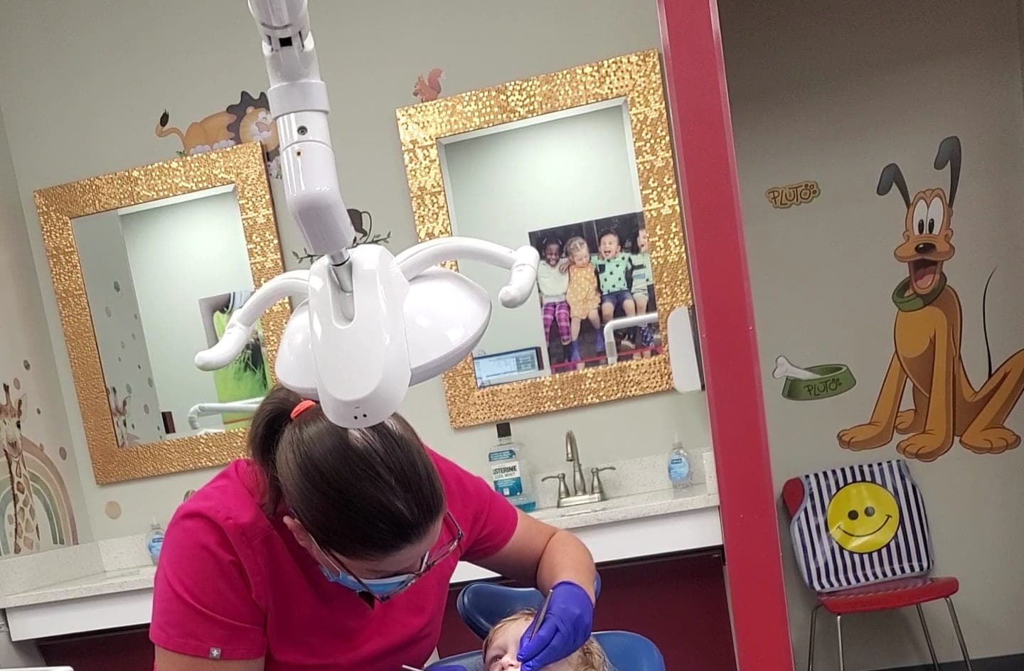 Hygienist gently cleaning a young patient's teeth